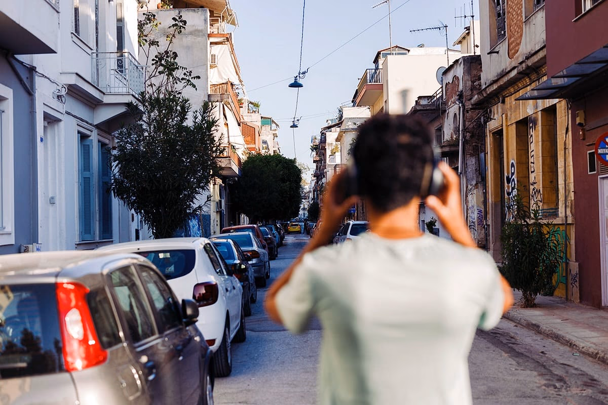 Traveller photographing a colourful Athens neighbourhood street