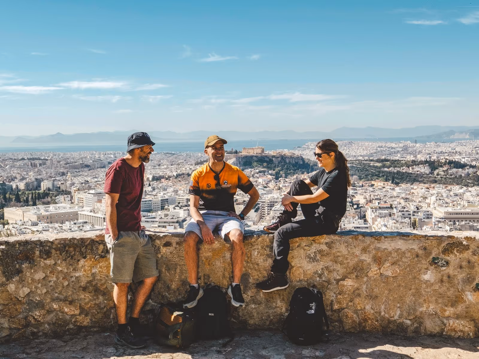 The hidden balcony viewpoint on Lycabettus Hill with two people looking at the Acropolis from a unique angle